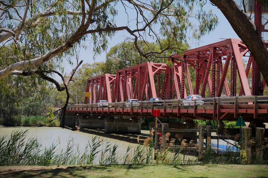 cars driving over red bridge 