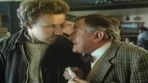 British Gas Still from the Tell Sid campaign of TV adverts encouraging people to invest in British Gas. It shows one man whispering to another.