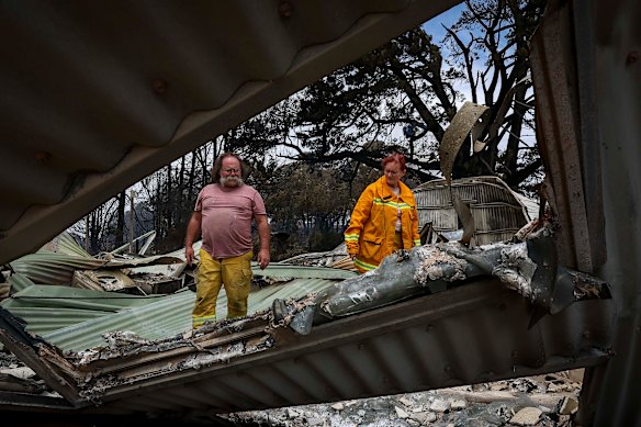 Ann and Jamie Laherty-Hunt examine the damage at their property.