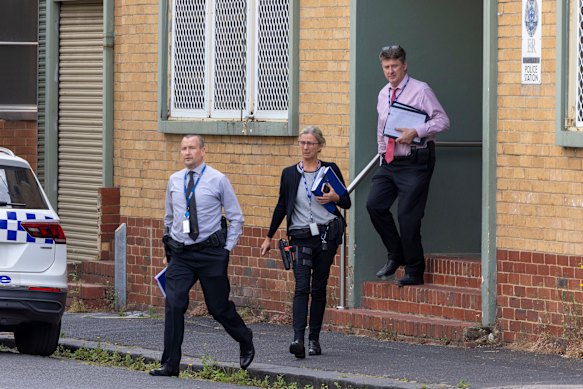 Investigators leave the Fitzroy police station on Saturday after a fatal shooting nearby the night prior.