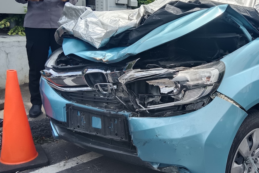 An image of a smashed up car bonnet.