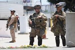 FILE - Members of the California National Guard and U.S. Marines guard a federal building on Tuesday, June 17, 2025, in Los Angeles.