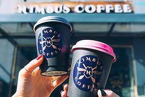 two Nimbus Coffee cups toast
