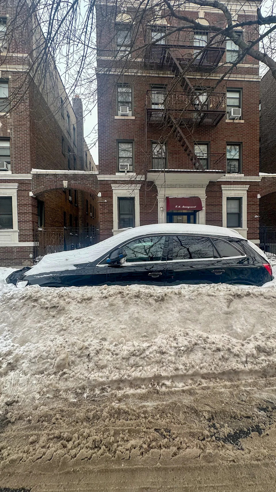 Car buried under snow from winter storm
