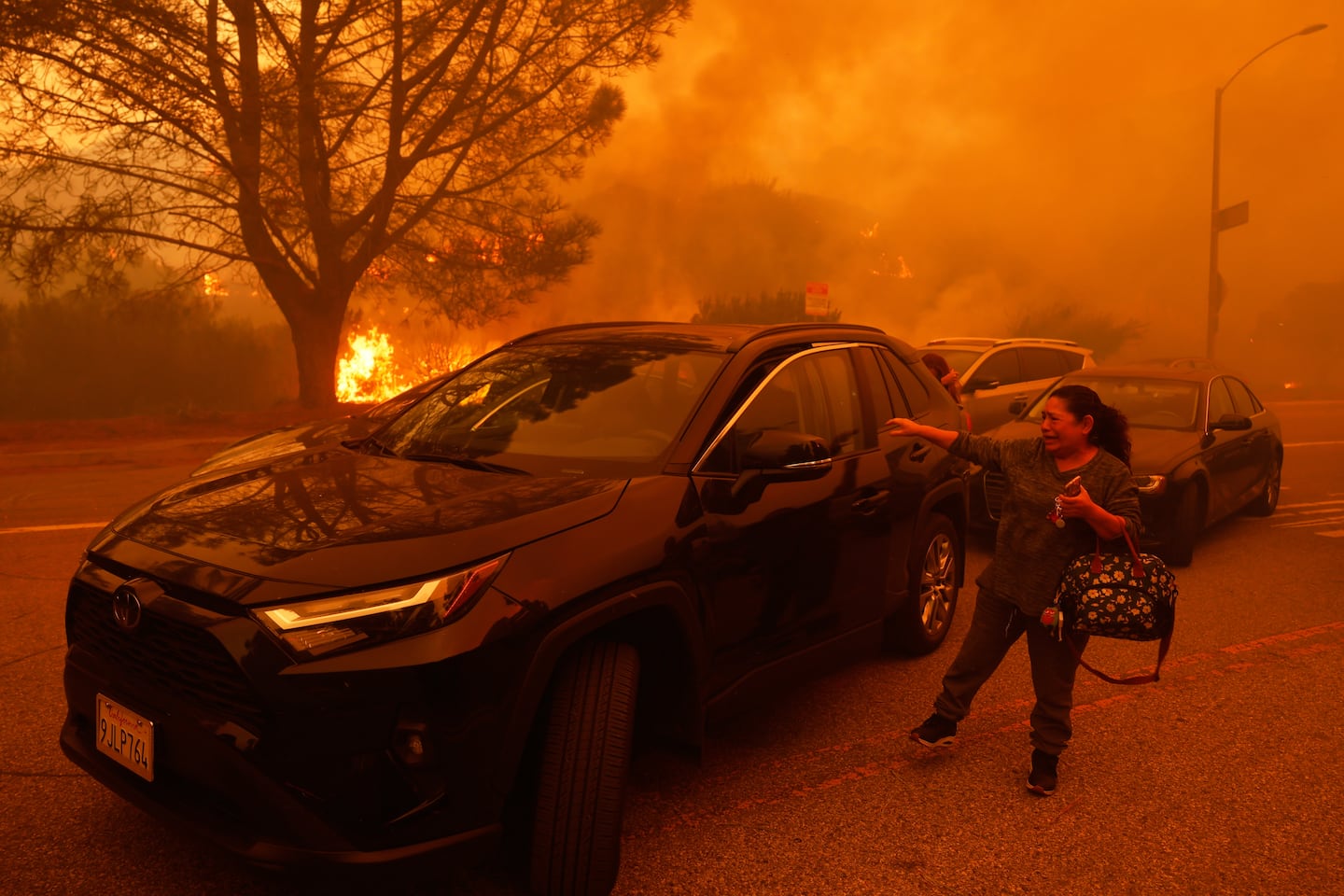 A woman cried as the Palisades Fire advanced in the Pacific Palisades neighborhood of Los Angeles, on Jan. 7, 2025.