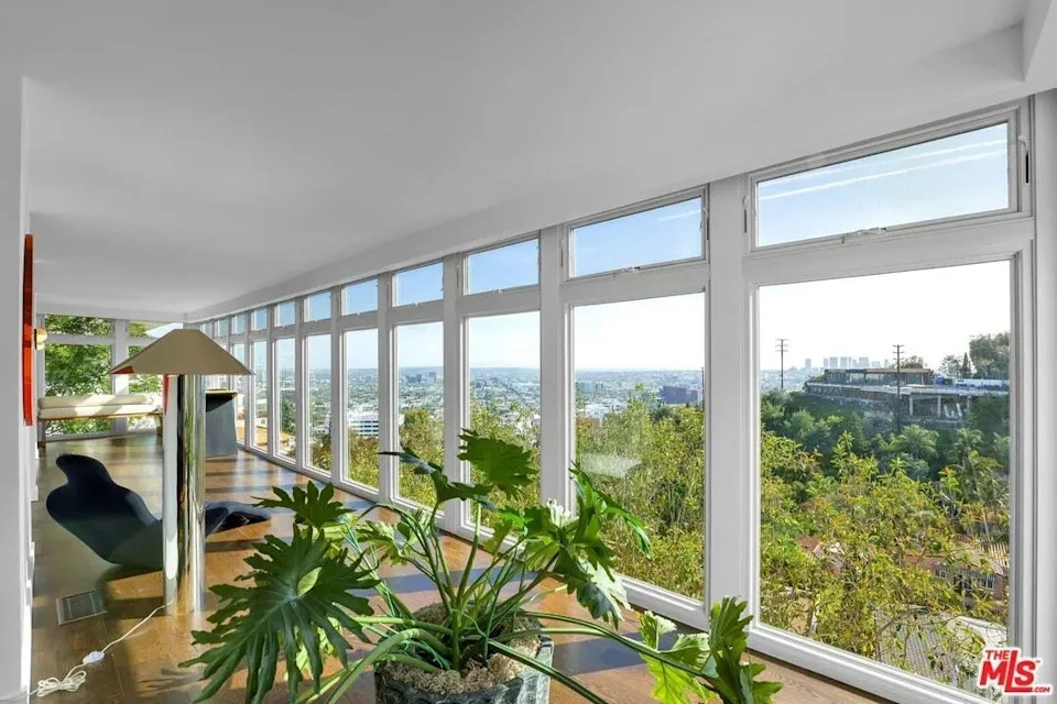 The home is also brimming with natural artwork, featuring floor-to-ceiling walls of glass that frame sweeping, vistas stretching from Downtown Los Angeles to the Pacific Ocean.