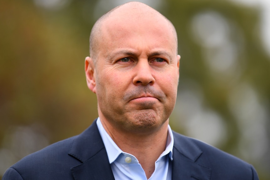 A close up image of Josh Frydenberg looking serious.