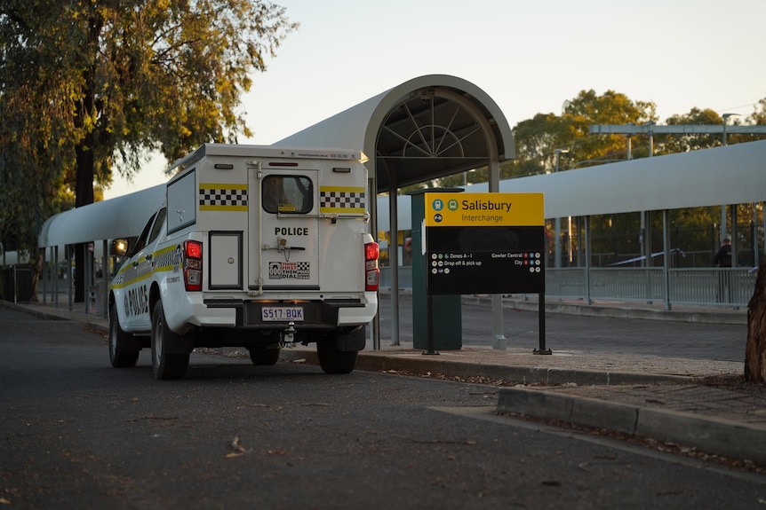 A police arrest wagon next to a bus stop with the sign Salisbury interchange