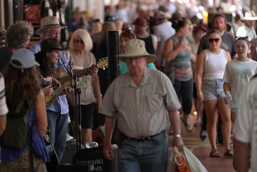A busy street in Tamworth where many people are walking on the footpath.