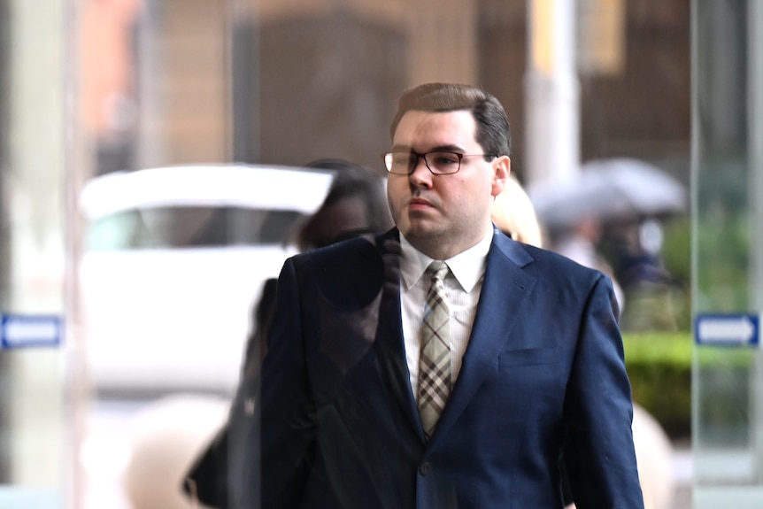 Bruce Lehrmann with a reflection on his face caused by glass doors.