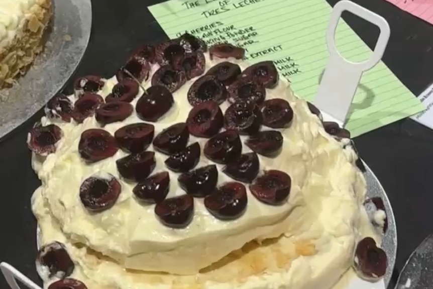 A cake with a piece of paper next to it.