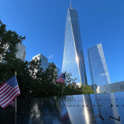 Flags are placed by the names of those killed during the Sept. 11, 2001, attacks at the reflecting pools at the National September 11 Memorial & Museum, Tuesday, Sept. 10, 2024, in New York. One World Trade Center rises in the background. AP Photo/Donald King