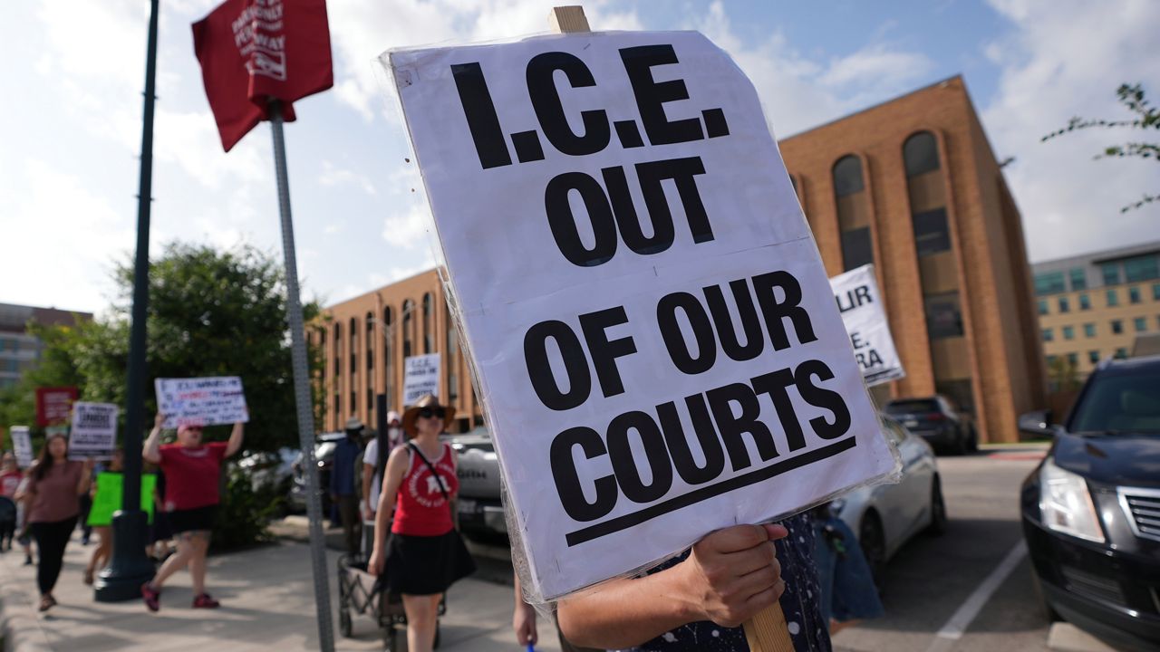 Immigration advocates protest recent detentions by ICE outside the immigration court in San Antonio, Texas, Tuesday, July 1, 2025. (AP Photo/Eric Gay)
