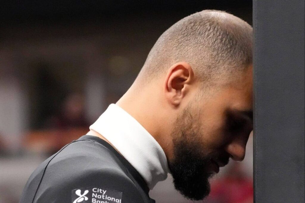 Orlando Magic guard Jalen Suggs rests his head against the backboard padding before a game against the Chicago Bulls.