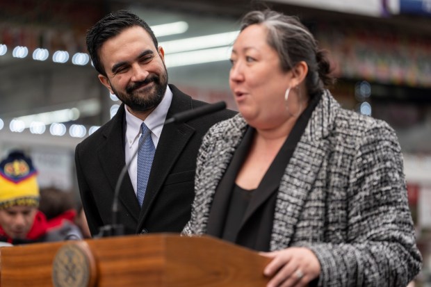 New York Mayor Zohran Mamdani, left, looks at Christine Clarke, right, Commissioner of the City Commission on Human Rights, speaks during a news conference, Wednesday, Jan. 7, 2026, in the Queens neighborhood of New York. (AP Photo/Yuki Iwamura)