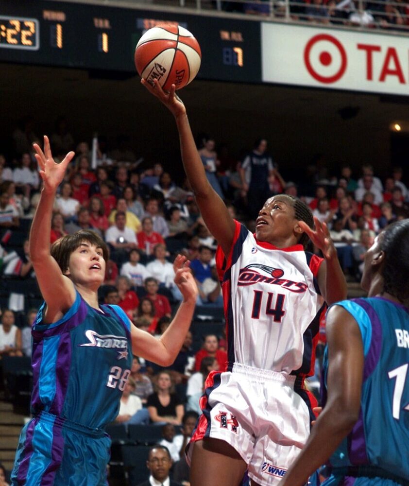 Houston Comets' Cynthia Cooper (14) goes up for a layup between Utah Starzz defenders Elena Baranova (28) and Cindy Brown (15) in this Aug. 16, 1999 file photo in Houston. One of 16 players who formed the core of the WNBA a decade ago, Cooper closed out her career in 2003 as one of the grand dames of the game and is among the leading candidates for the WNBA's All-Decade Team.