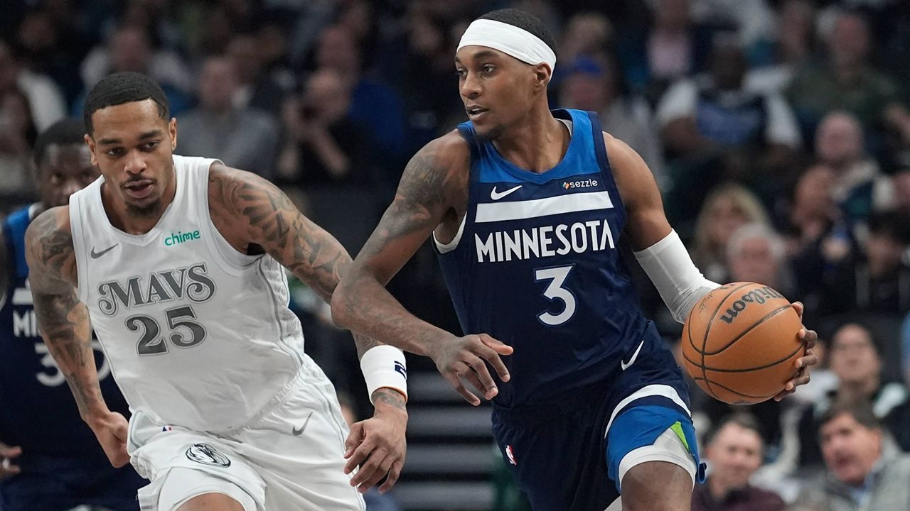 Minnesota Timberwolves forward Jaden McDaniels (3) drives past Dallas Mavericks forward P.J. Washington (25) during the first half of an NBA basketball game Wednesday, Jan. 22, 2025, in Dallas. (AP Photo/LM Otero)