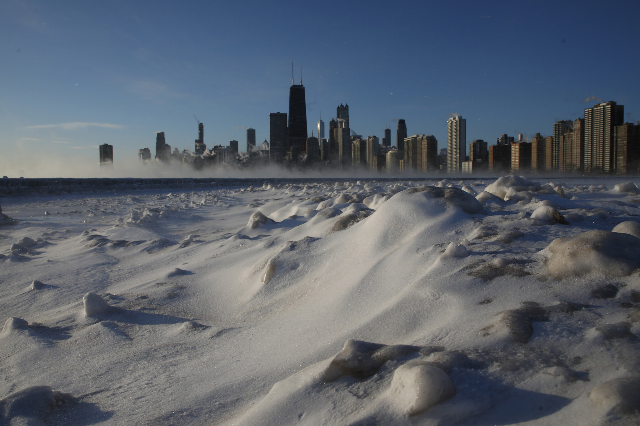 The sunrise reveals a frigid Chicago lakefront with temperatures around...