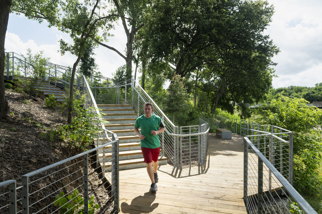 Man jogging along trail at Bayou Park
