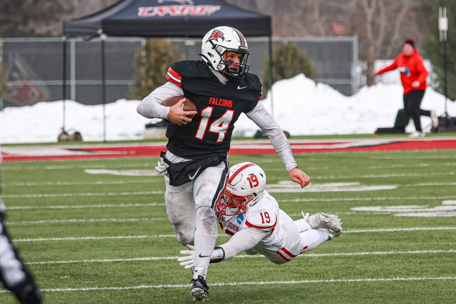 UWRF quarterback Kaleb Blaha scrambles past a diving tackler during a win this season.