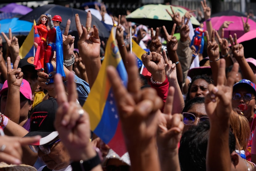 Government supporters gather for a women's march to demand the return of Venezuelan...