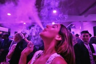 A guest takes a puff from a marijuana cigarette at the Sensi Magazine party celebrating the...