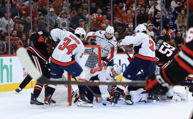 A scrum ensues at the Capitals goal in the first period against the Blackhawks at the United Center on Jan. 9, 2026, in Chicago. (John J. Kim/Chicago Tribune)