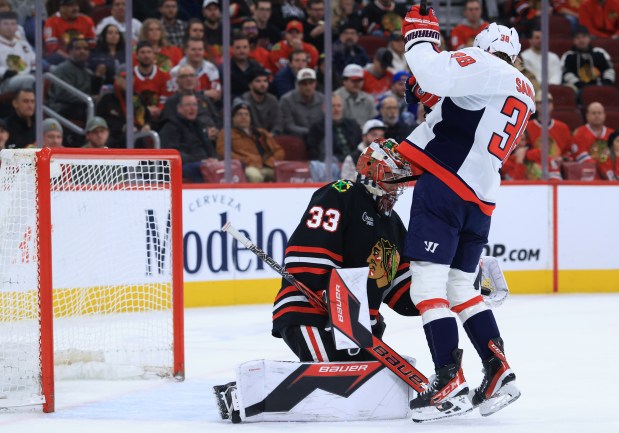Blackhawks goaltender Drew Commesso (33) catches the puck as Capitals defenseman Rasmus Sandin (38) stops short of a collision in the second period at the United Center on Jan. 9, 2026, in Chicago. (John J. Kim/Chicago Tribune)