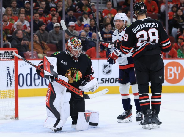Blackhawks goaltender Drew Commesso (33) handles the puck after a stop in the second period against the Capitals at the United Center on Jan. 9, 2026, in Chicago. (John J. Kim/Chicago Tribune)