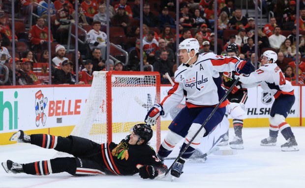 Blackhawks center Colton Dach (34) falls on the ice in the third period against the Capitals at the United Center on Jan. 9, 2026, in Chicago. (John J. Kim/Chicago Tribune)