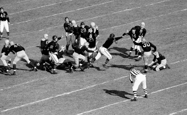 The Green Bay Packers line failed to hold when Clark Hinkle (3), Packers back, tried a field goal in the first period of the NFL's Western Division title game against the Chicago Bears at Wrigley Field in Chicago, on Dec. 14, 1941. The Bears won 33-14. Here John Siegel, Beasr end, rushes in on the ball as it leaves Hinkle's foot, with teammates Dick Plasman (14), Dan Fortmann (21) and Ed Kolman (29) backing him up in bringing the ball down on the Bears' 31. Herman Rohrig (8), Packers back, is also seen. (Harry L. Hall/AP)