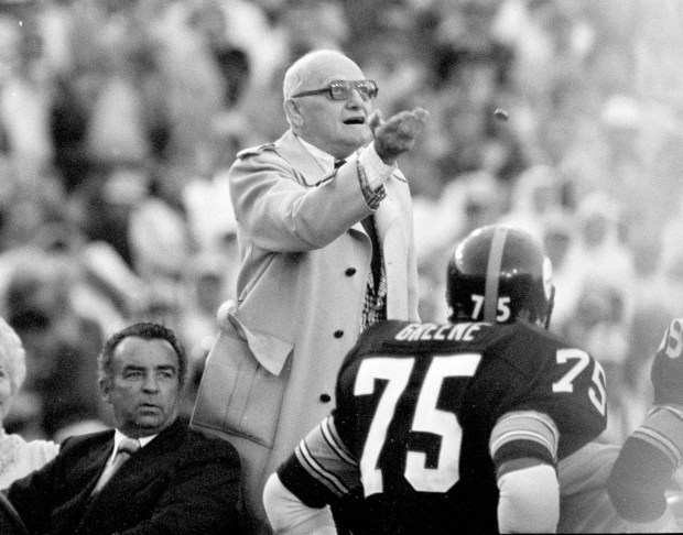 George Halas, owner of the Chicago Bears, flips the opening game coin toss to determine which team will receive the kickoff in Super Bowl XIII, Jan. 21, 1979, in Miami. The Pittsburgh Steelers played the Dallas Cowboys. The Cowboys won the toss. (AP Photo/Phil Sandlin)