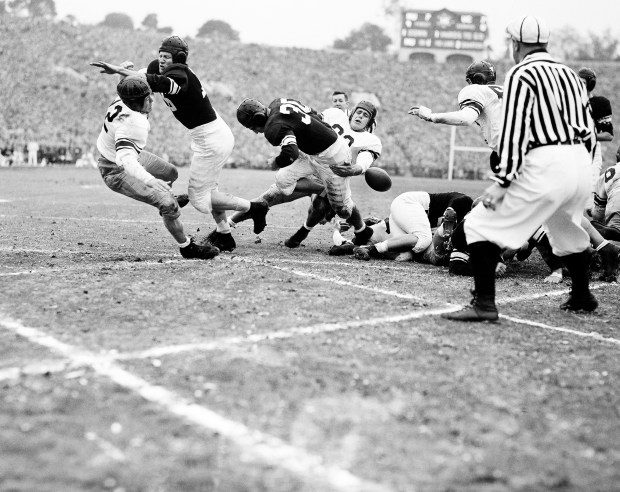 Art Murakowski (30), Northwestern fullback, fumbles the ball as he crosses the goal line from one yard out against California at the Rose Bowl in Pasadena, California, on Jan. 1, 1949. Northwestern won the New Year's Day classic, 20-14. (AP)