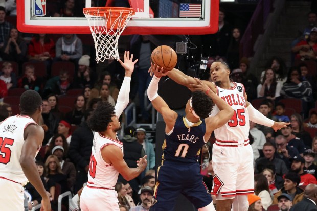 Bulls guard Tre Jones (30) and forward/guard Isaac Okoro (35) defend against Pelicans guard Jeremiah Fears (0) in the first half at the United Center on Wednesday, Dec. 31, 2025. (Terrence Antonio James/Chicago Tribune)