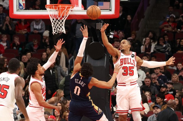 Bulls guard Tre Jones (30) and forward/guard Isaac Okoro (35) defend against Pelicans guard Jeremiah Fears (0) in the first half at the United Center on Wednesday, Dec. 31, 2025. (Terrence Antonio James/Chicago Tribune)