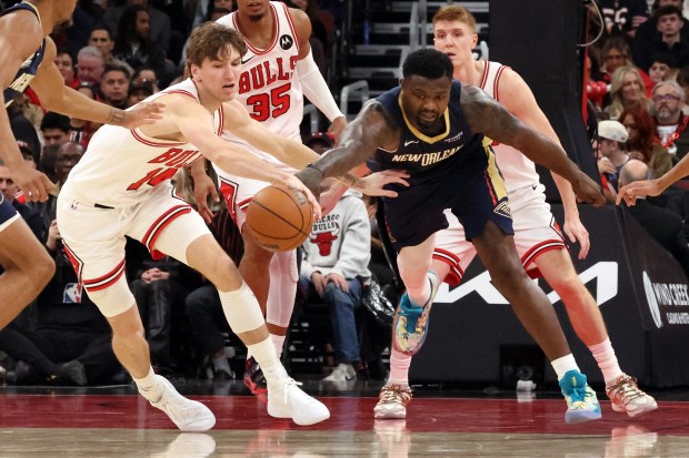 Bulls forward Matas Buzelis (14) pokes the ball away from Pelicans forward Zion Williamson (1) in the first half at the United Center on Wednesday, Dec. 31, 2025. (Terrence Antonio James/Chicago Tribune)