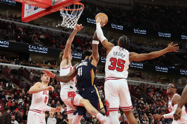 Bulls forward/guard Isaac Okoro (35) blocks a shot by Pelicans guard/forward Saddiq Bey (41) in the second half at the United Center on Wednesday, Dec. 31, 2025. The Bulls won 134 - 118. (Terrence Antonio James/Chicago Tribune)