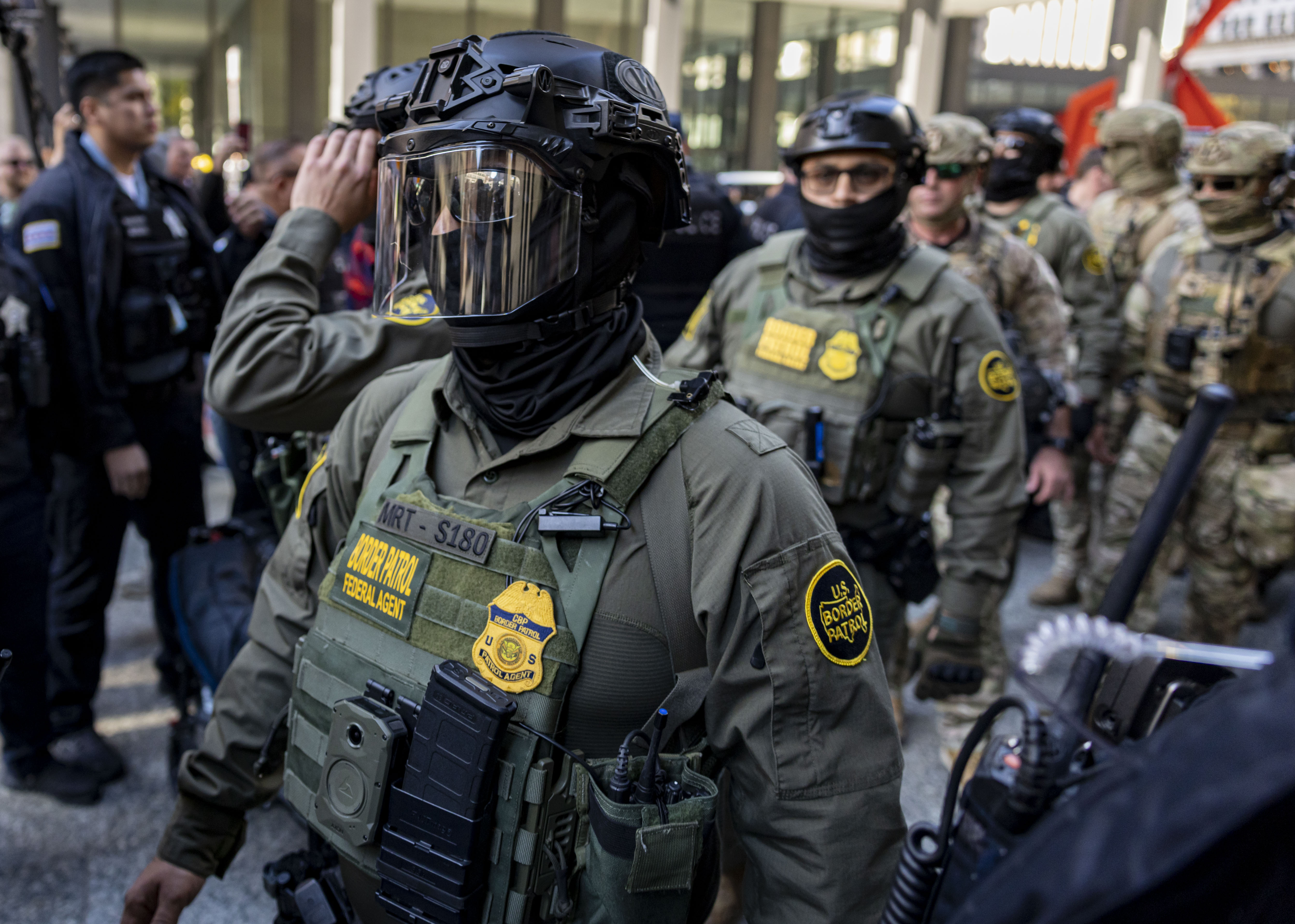 Border Patrol agents arrive to escort Cmdr. Gregory Bovino from...