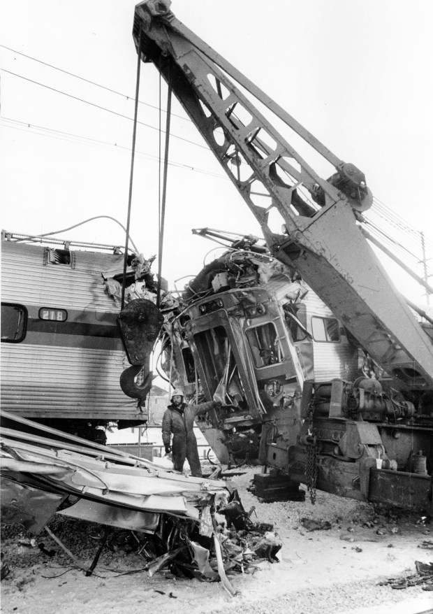 Crews separate two commuter trains that crashed on Jan. 21, 1985, in Gary, Indiana. Federal safety experts began interviewing crews, dispatchers and management officials in their investigation into the head-on collision, as rail industry veterans theorized that human error was the probable cause. (John Dziekan/Chicago Tribune)