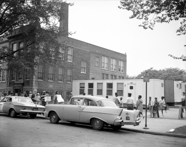 People picket the use of mobile classrooms that were placed next to Guggenheim Elementary School at 7146 S. Sangamon St. in Chicago in 1963. (Al Phillips/Chicago Tribune)