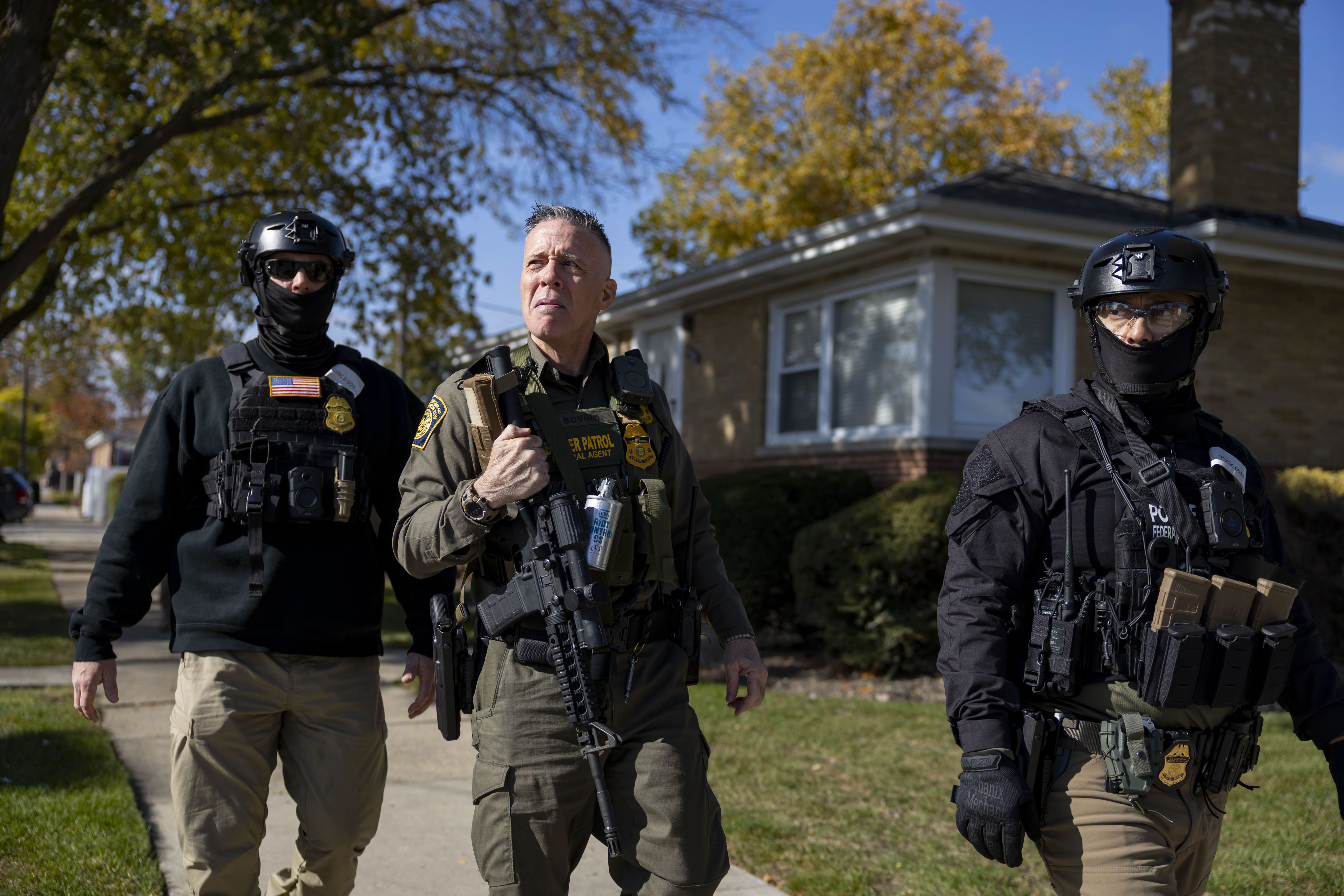 U.S. Border Patrol Cmdr. Gregory Bovino walks with agents while...