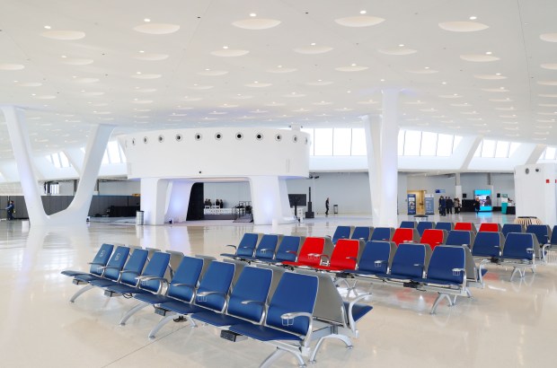 People walk through the newly expanded Terminal 5 at O'Hare International Airport on Tuesday, Jan. 31, 2023, in Chicago. The new expansion includes 350,000 square feet of vaulted ceilings, natural light, and floor to ceiling high-performance glass offering an expansive view of the airfield.. (Stacey Wescott/ChicagoTribune)