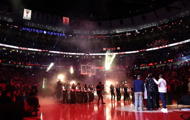 Derrick Rose stands with his loved ones while looking at his raised banner after his #1 jersey was retired by the Chicago Bulls at the United Center in Chicago on Jan. 24, 2026. (Chris Sweda/Chicago Tribune)