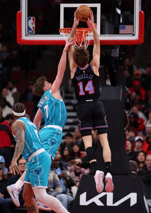 Chicago Bulls forward Matas Buzelis (14) dunks on Charlotte Hornets guard/forward Kon Knueppel (7) in the first half of a game at the United Center in Chicago on Jan. 3, 2026. (Chris Sweda/Chicago Tribune)