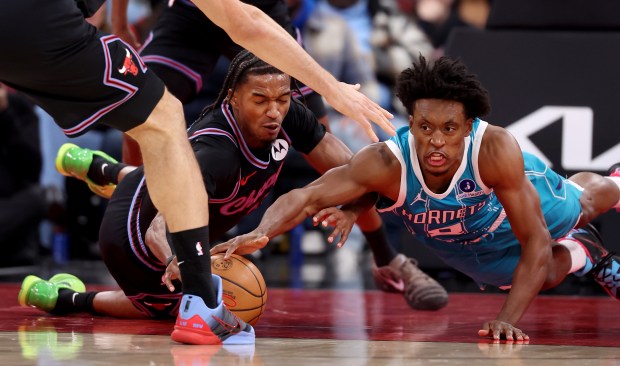 Bulls forward Julian Phillips and Hornets guard Collin Sexton battle for a loose ball in the second half Jan. 3, 2026, at the United Center. (Chris Sweda/Chicago Tribune)