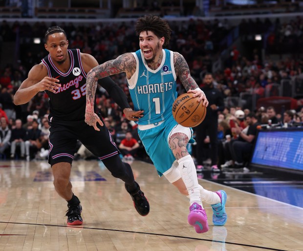 Charlotte Hornets guard Lamelo Ball (1) drives on Chicago Bulls forward/guard Isaac Okoro (35) in the first half of a game at the United Center in Chicago on Jan. 3, 2026. (Chris Sweda/Chicago Tribune)