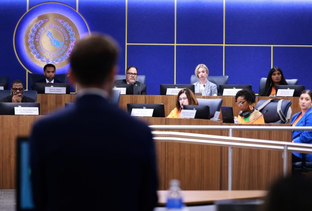 People speak in front of the Chicago Board of Education at a meeting on Aug. 13, 2025. (Antonio Perez/Chicago Tribune)
