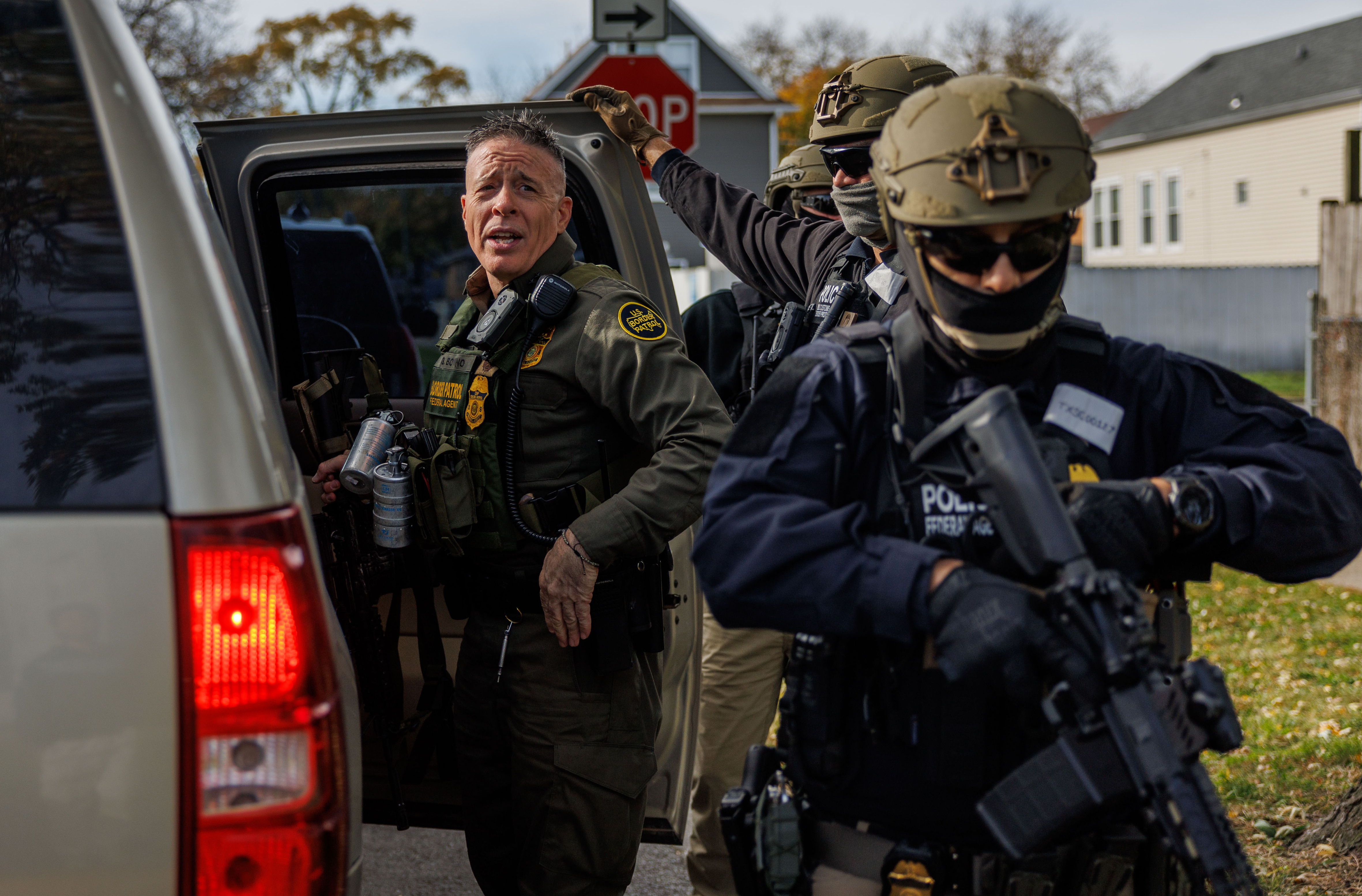 Border Patrol Cmdr. Gregory Bovino walks with other agents while...