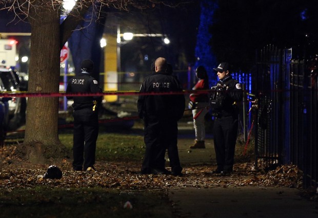 Chicago police guard a crime scene in the 5700 block of South May Street in Chicago after 13 people were shot on Dec. 22, 2019. (Terrence Antonio James/Chicago Tribune)