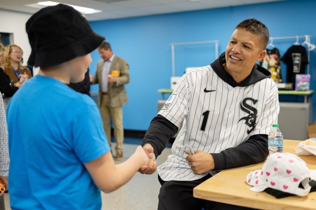 Nicholas, left, shakes hands with White Sox manager Will Venable during a community event Thursday, Jan. 29, 2026, at the Bartlett J. McCartin Boys & Girls Club in Bridgeport. (Josh Boland/Chicago Tribune)
